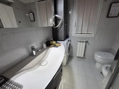 a bathroom with a sink and a toilet at Lilli Home - Urban Garden in Rome