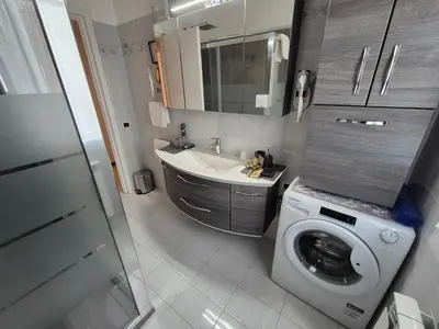 a bathroom with a washing machine and a sink at Lilli Home - Urban Garden in Rome