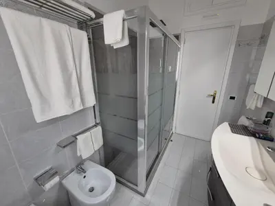 a bathroom with a shower and a toilet and a sink at Lilli Home - Urban Garden in Rome