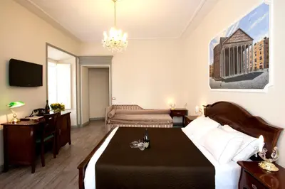 a bedroom with a bed with a table and a tv at Sleep In Rome Ludovisi in Rome