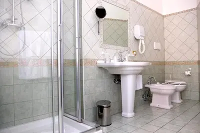 a bathroom with a sink and a toilet and a shower at Sleep In Rome Ludovisi in Rome
