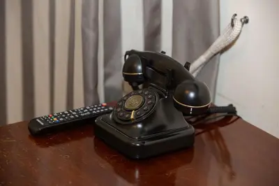 a telephone and a remote control sitting on a table at Sleep In Rome Ludovisi in Rome