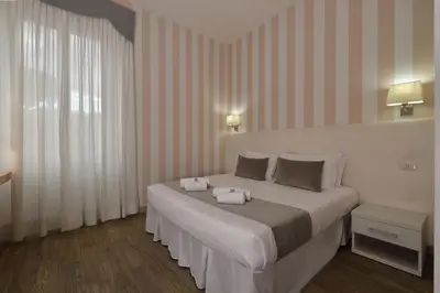 a bedroom with a bed with two towels on it at Rome Vatican Inn in Rome