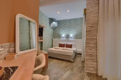 a living room with a bed and a couch at Rome Vatican Inn in Rome