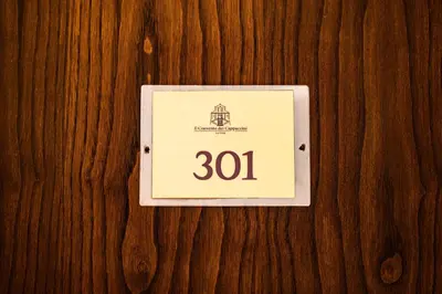 a switch on a wooden wall with the number at Casa I Cappuccini in Rome