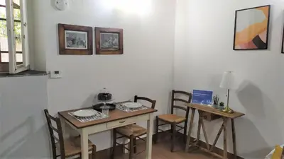 a dining room with a table and two chairs at Stranamore Apartments Trastevere in Rome