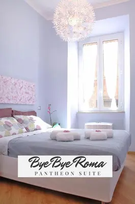a bedroom with a large bed with a chandelier at Bye Bye Roma Pantheon Suite in Rome