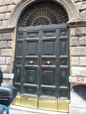 a large black door on the side of a building at Bye Bye Roma Pantheon Suite in Rome