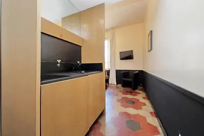 a bathroom with a sink and a counter in a room at Michelangelo Charmsuite in Rome