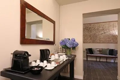 a room with a table with cups and a mirror at RESIDENZA VITTORIA Roma in Rome