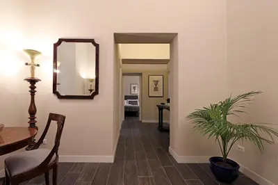a hallway with a table and a mirror and a plant at RESIDENZA VITTORIA Roma in Rome