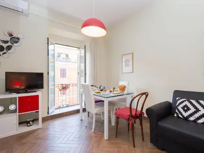 a living room with a dining room table and a couch at Apartment Regina's House - St Peter by Interhome in Rome