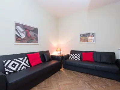a living room with two black couches and a table at Apartment Regina's House - St Peter by Interhome in Rome