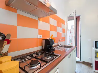 a kitchen with a stove and a sink at Apartment Regina's House - St Peter by Interhome in Rome