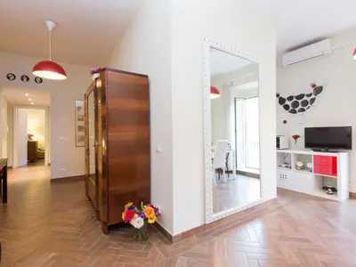 a living room with a large mirror on the wall at Apartment Regina's House - St Peter by Interhome in Rome