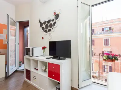 a living room with a tv and a large window at Apartment Regina's House - St Peter by Interhome in Rome