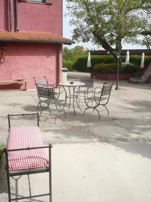 a group of chairs and a table in front of a building at Il Baffetto B&B in Rome