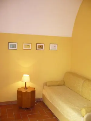 a room with a couch and a table with a lamp at Il Baffetto B&B in Rome
