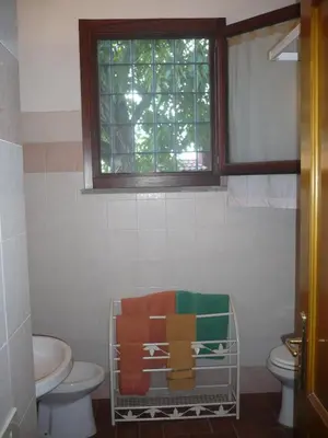 a bathroom with a toilet and a sink and a window at Il Baffetto B&B in Rome
