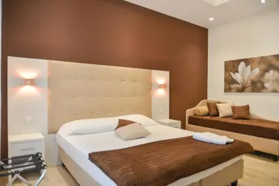 a bedroom with a large bed and a couch at Your Rhome in Rome