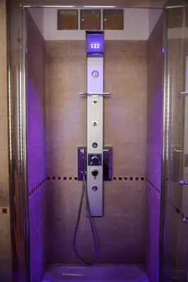 a shower in a bathroom with a blue light at Your Rhome in Rome