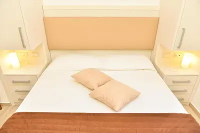 a bed in a small room with two lamps at Your Rhome in Rome