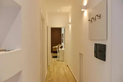 a hallway leading to a living room with a television and a hallway at Your Rhome in Rome