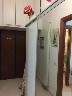 a bedroom with a bed and a refrigerator at Aquila 52 in Rome