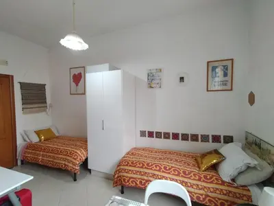 a bedroom with a bed with towels on it at Aquila 52 in Rome
