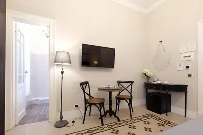 a living room with a table and chairs and a tv at Residenza Mazzini in Rome