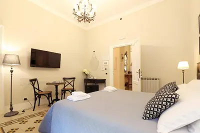 a bedroom with a bed and a desk and a television at Residenza Mazzini in Rome