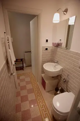 a bathroom with a white toilet and a sink at Residenza Mazzini in Rome