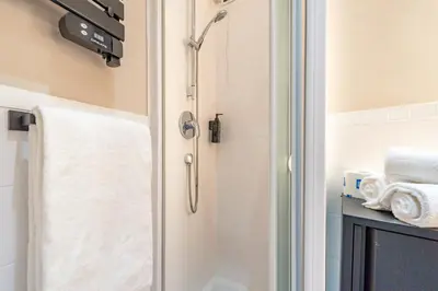 a hotel room with a bed and a television on the wall at Crescenzio 74 Boutique Guest House by Ghor in Rome