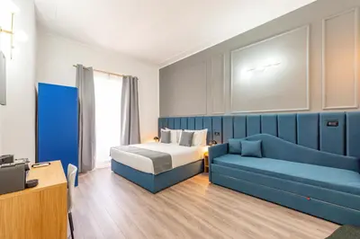 a hallway with blue walls and a rug on the floor at Crescenzio 74 Boutique Guest House by Ghor in Rome