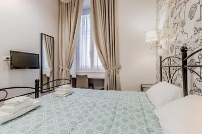 a bedroom with a large bed and a television at B&B Trastevere 94 in Rome