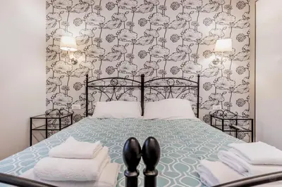 a bedroom with a bed with black shoes on it at B&B Trastevere 94 in Rome