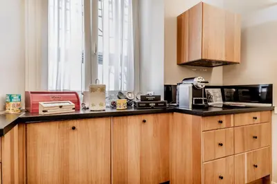 a kitchen with wooden cabinets and a counter top at B&B Trastevere 94 in Rome