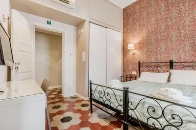 a small bedroom with a bed and a bathroom at B&B Trastevere 94 in Rome