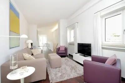 a living room with a couch and chairs and a tv at Crispi Luxury Apartments - My Extra Home in Rome