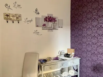 a bedroom with a bed and a table and a chair at Guest House Casa Vicenza in Rome