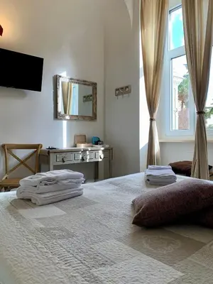 a bedroom with a bed with towels on it at Guest House Casa Vicenza in Rome