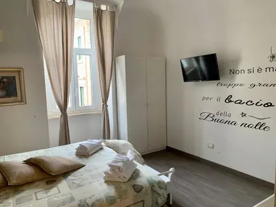 a bedroom with a bed with two pillows on it at Guest House Casa Vicenza in Rome