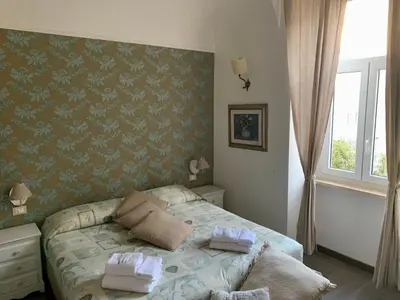 a bedroom with a bed and a desk and a mirror at Guest House Casa Vicenza in Rome
