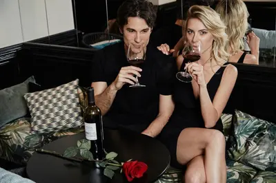 a man and woman sitting on a couch drinking wine at HOTEL VITE - By Naman Hotellerie in Rome