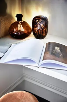 an open book sitting on a table next to a lamp at HOTEL VITE - By Naman Hotellerie in Rome