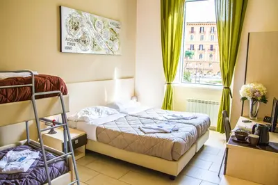 a bedroom with a bed and a window at Mosaic Central Guest House in Rome