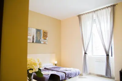 a bedroom with a bed and a window at Mosaic Central Guest House in Rome