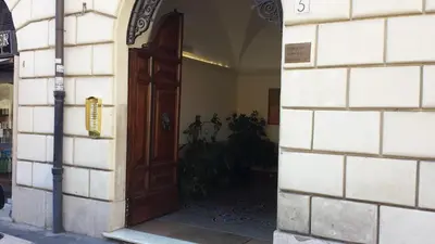 an entrance to a building with a wooden door at Mosaic Central Guest House in Rome