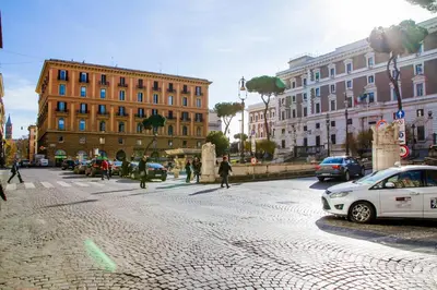 a city street with cars parked on a brick road at Mosaic Central Guest House in Rome
