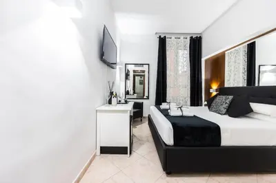 a hotel room with a bed and a television at Hotel Max in Rome